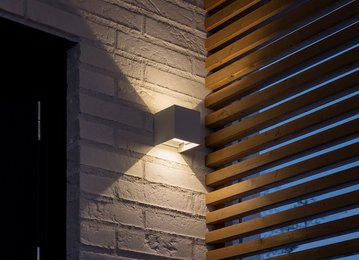 FUNK wall light on a white brick wall.